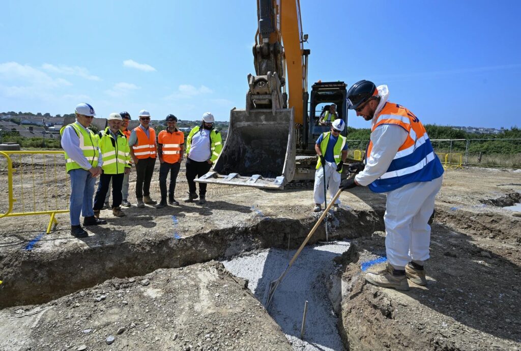 Construction team with a surveying tool at the Duchy of Cornwall housing site for the Nansledan Newquay development.