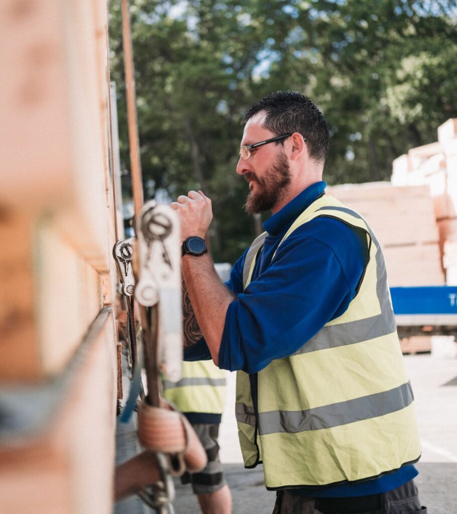 Marcus Bienek securing timber materials on a delivery vehicle at Sydenhams Timber Engineering